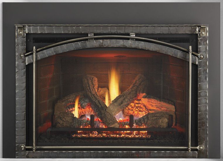 A fireplace insert with an arched surround set into an existing opening